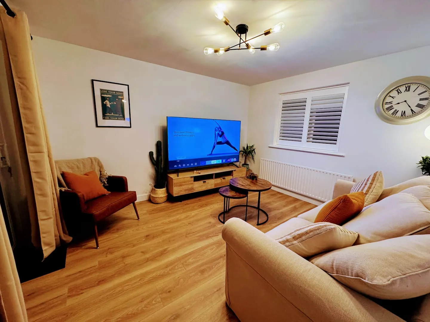 Living room with sofa, armchair and a big TV