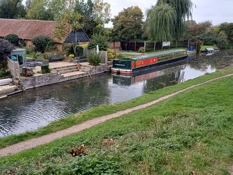 The John Pinkerton II trip boat moored by Colt Hill Bridge on the Basingstoke Canal