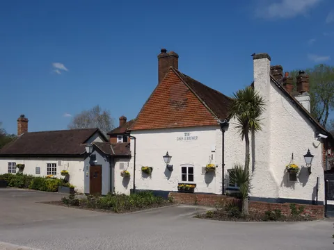 The Waterwitch, a white-painted pub with a tiled roof by the canal at Colt Hill