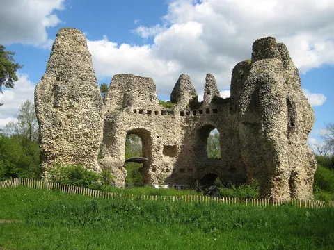 The flint ruins of Odiham Castle's eight-sided keep against a blue sky